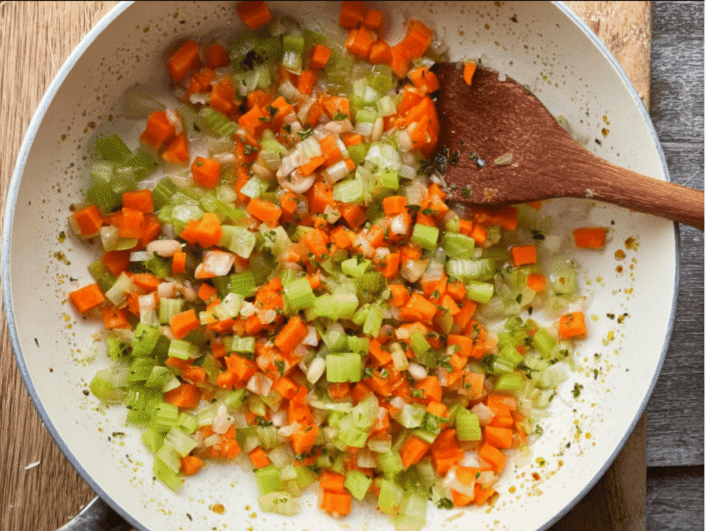 Sautéing carrots, celery, and onions to start how to make ham and bean soup