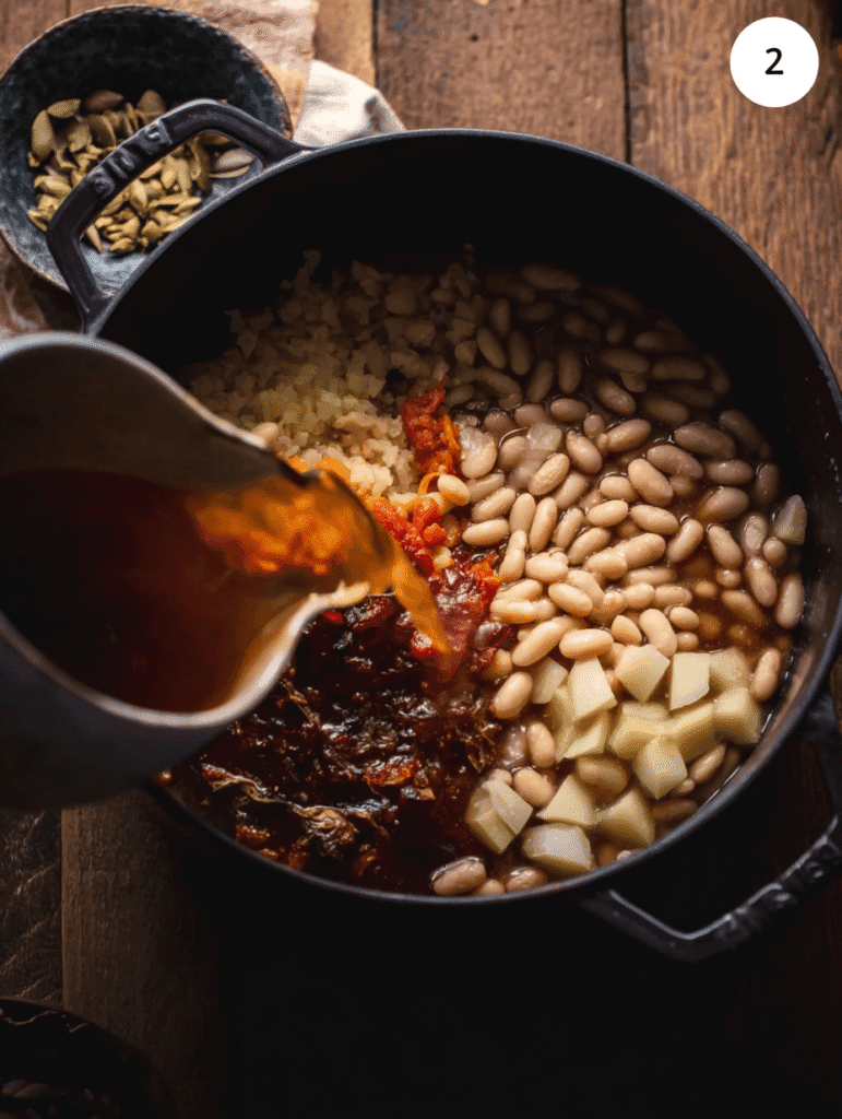 Adding beans, broth, and vegetables to authentic Italian minestrone soup