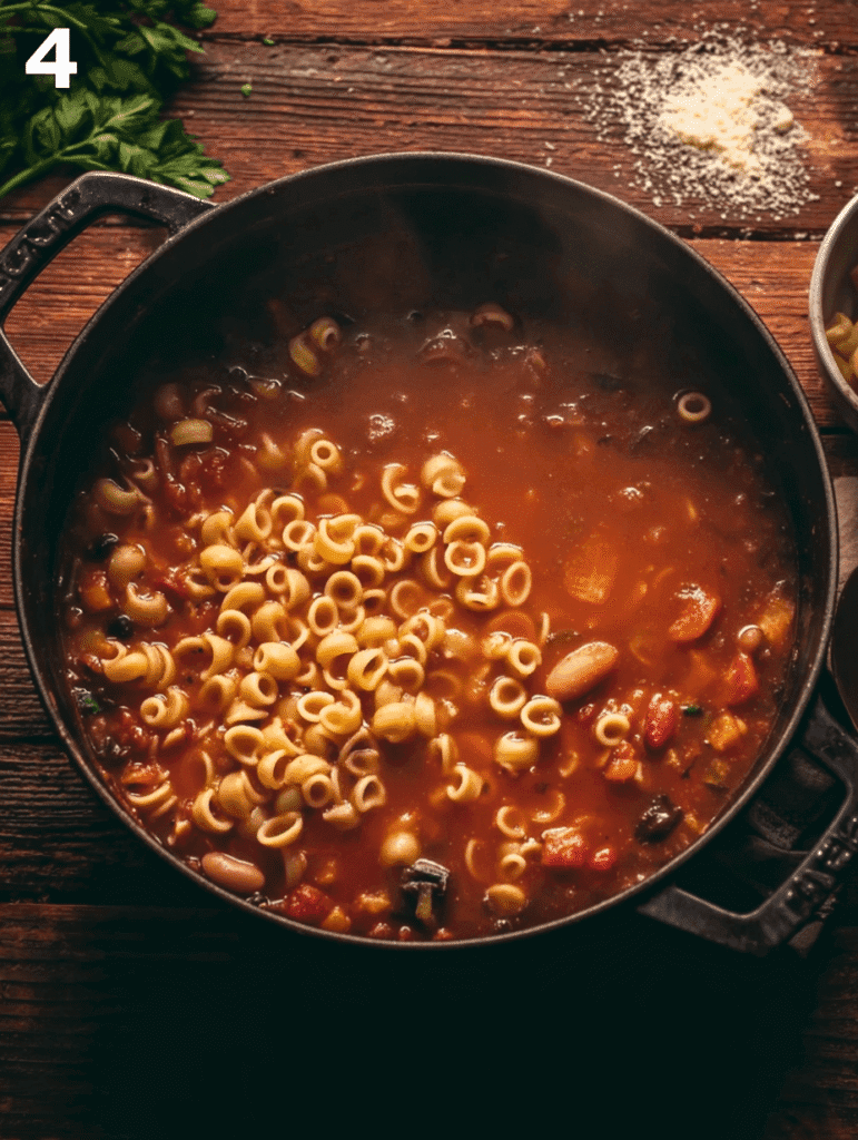Adding pasta to authentic Italian minestrone soup as it simmers