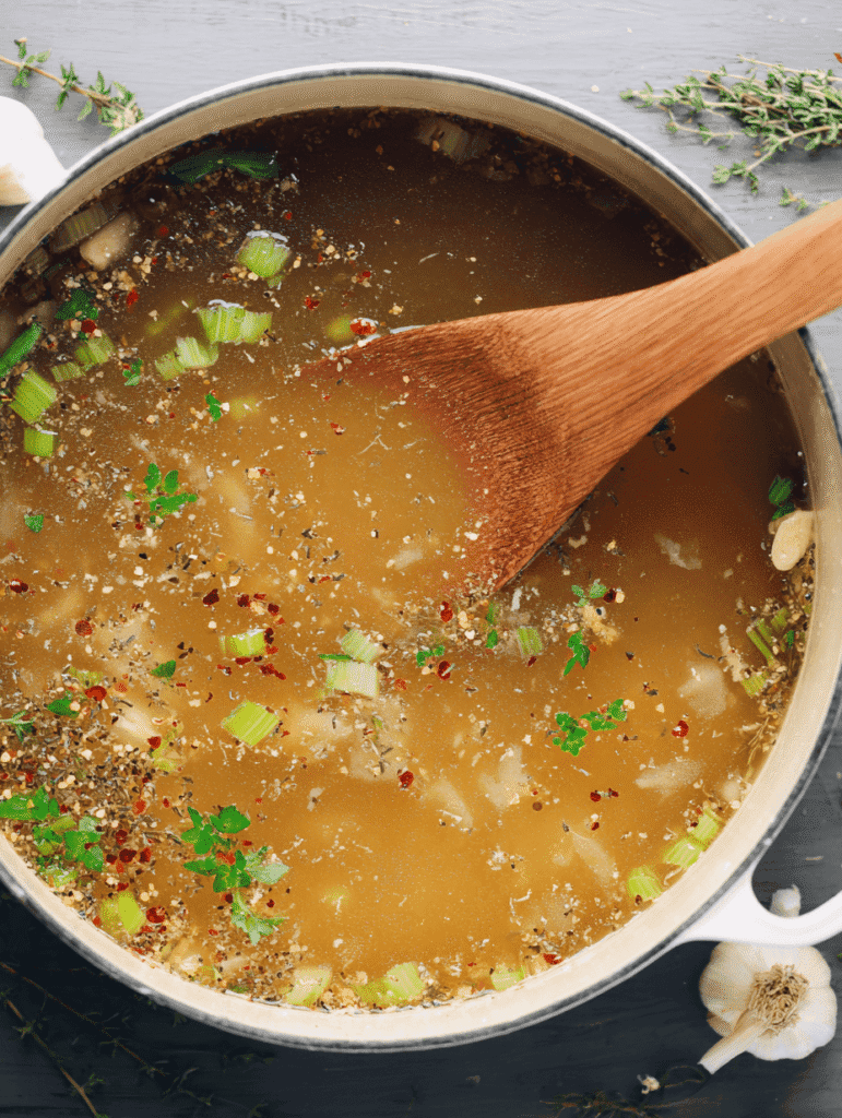 High Protein Chicken Noodle Soup – The Ultimate Cozy 30-Minute Meal 6 Simmering chicken bone broth with celery, onions, and spices for High Protein Chicken Noodle Soup.