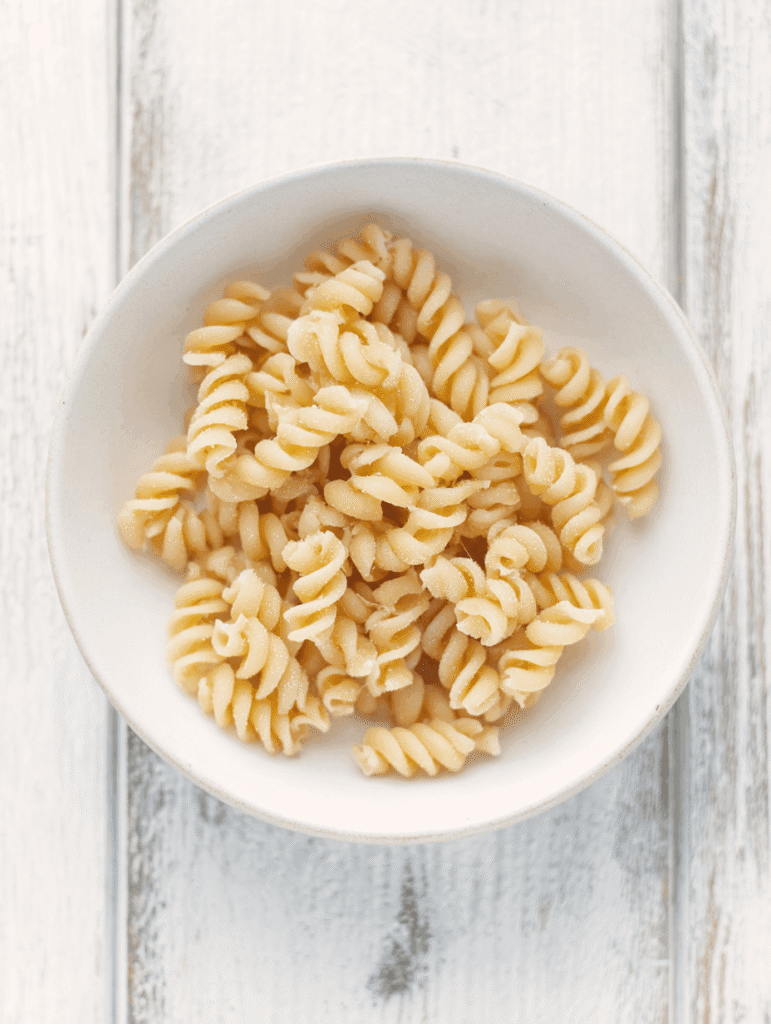 High Protein Chicken Noodle Soup – The Ultimate Cozy 30-Minute Meal 8 Cooked curly chickpea pasta in a bowl for High Protein Chicken Noodle Soup.