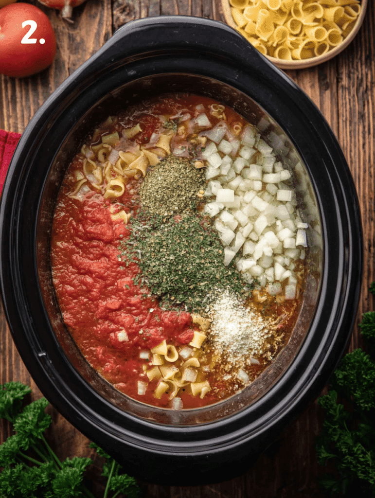 Lasagna soup crockpot step 2 showing onions, herbs, and marinara added to slow cooker