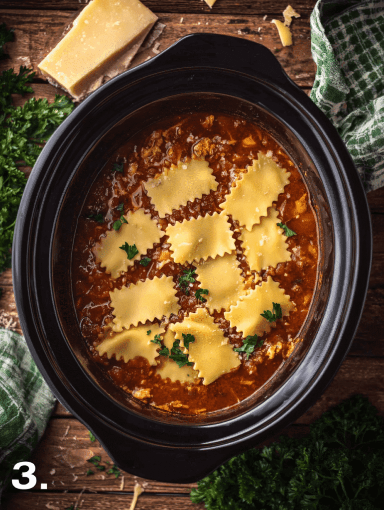 Lasagna soup crockpot step 3 adding broken lasagna noodles to tomato broth