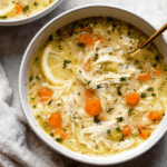 is lemon chicken orzo soup healthy — fresh homemade lemon chicken orzo with carrots, chicken, and lemon slice in a creamy broth