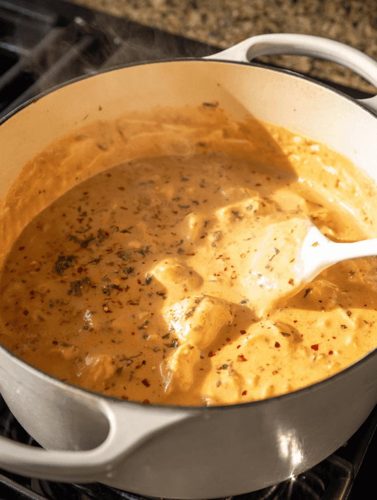 Creamy sauce simmering in pot for Marry Me Chicken Gnocchi Soup