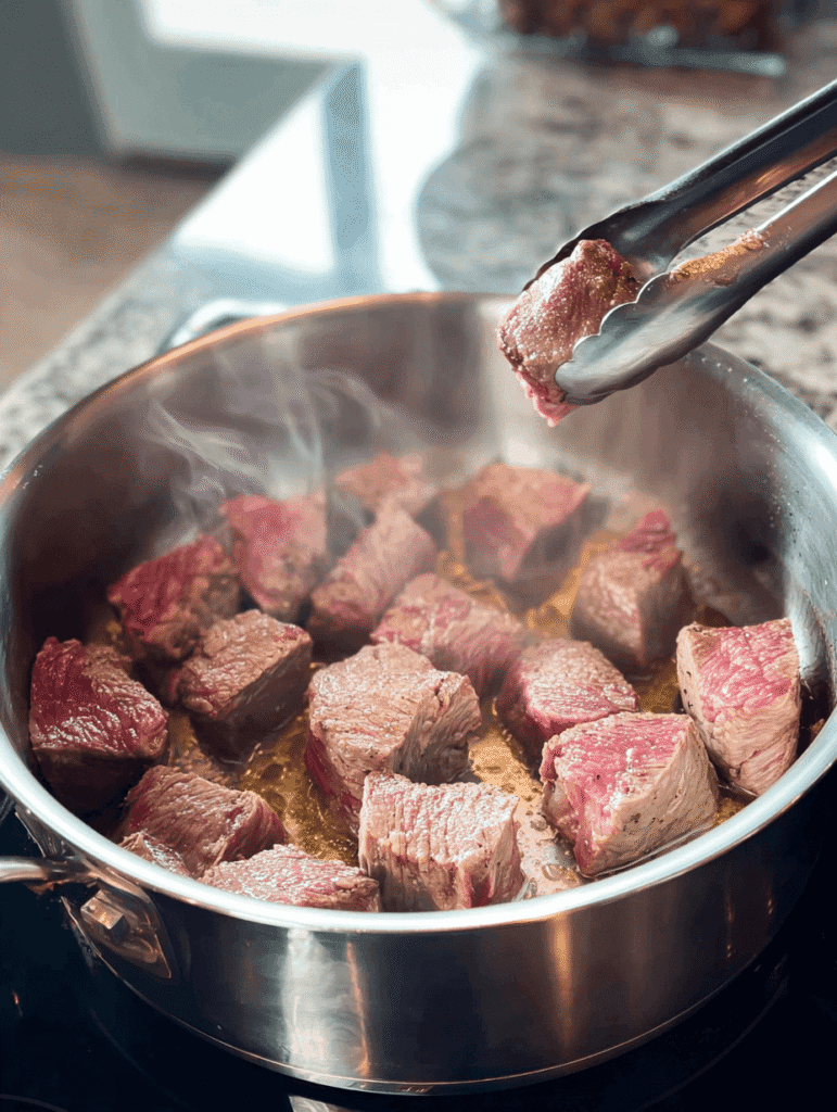 Searing beef cubes in a stainless steel pot for Old Fashioned Vegetable Beef Soup